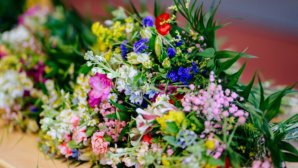 Bouquets of flowers lie on a table. 