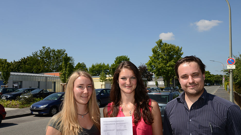 Foto (v. l.): Die beiden Studentinnen Lena Zingraff und Anastasia Völker mit dem Fragenbogen und Dr. Andreas Bielawny von der brandenburg gmbh in der Goerdelerstraße, deren Lampen bereits mit der LED-Technik ausgestattet sind.