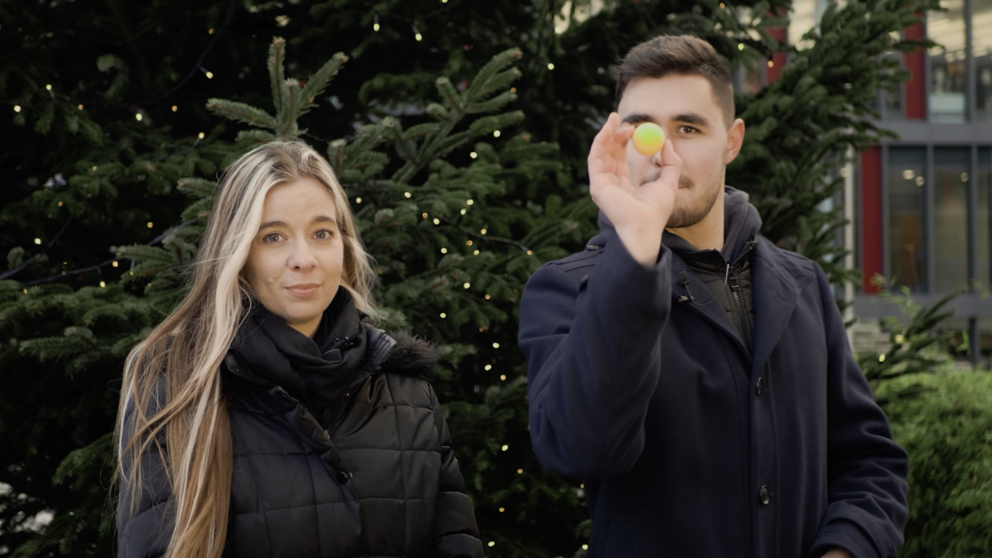 Moderators in front of the Christmas tree